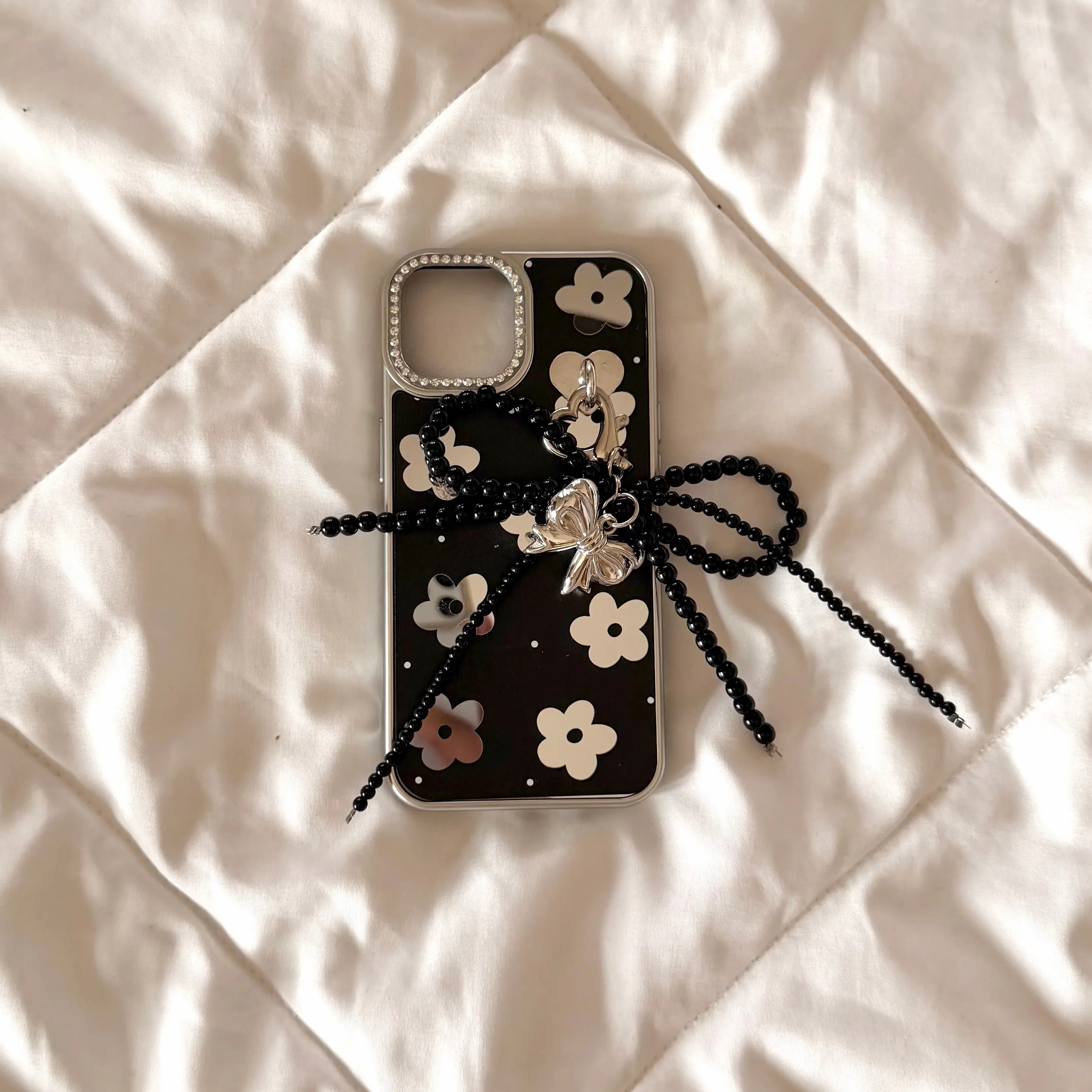 Black floral case with pearl charm