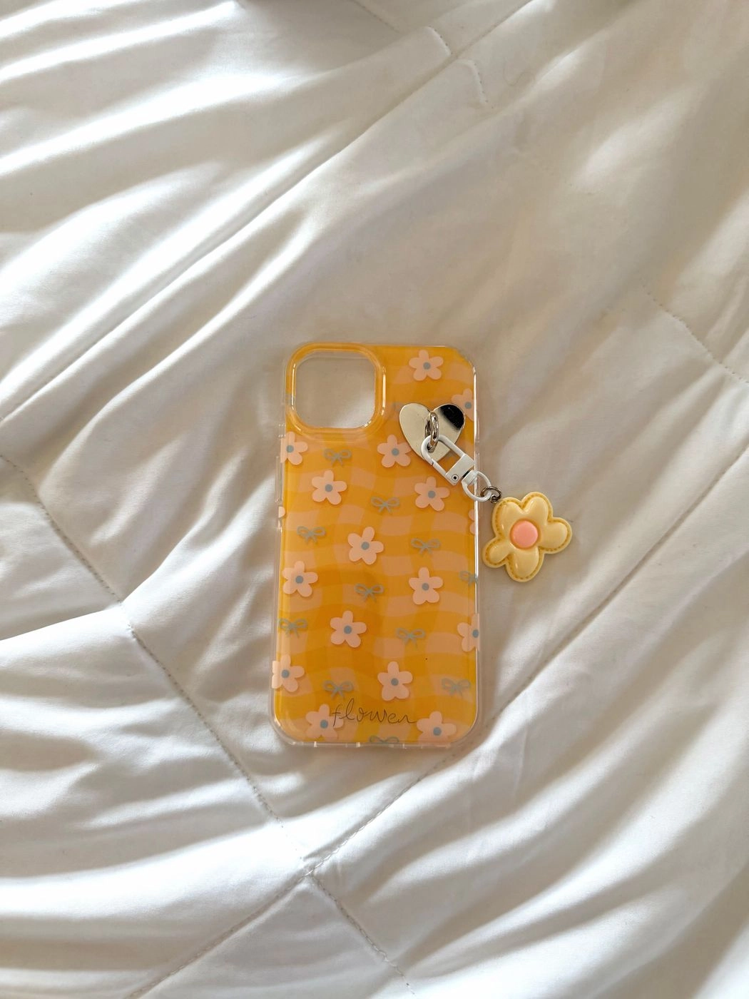 Yellow floral phone case with daisy charm